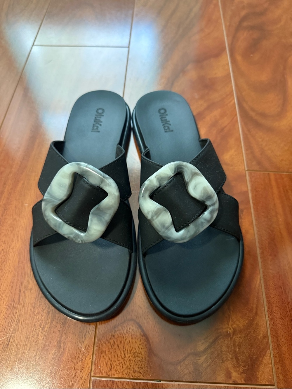 Olukai Black Slide Sandals with Decorative Buckle